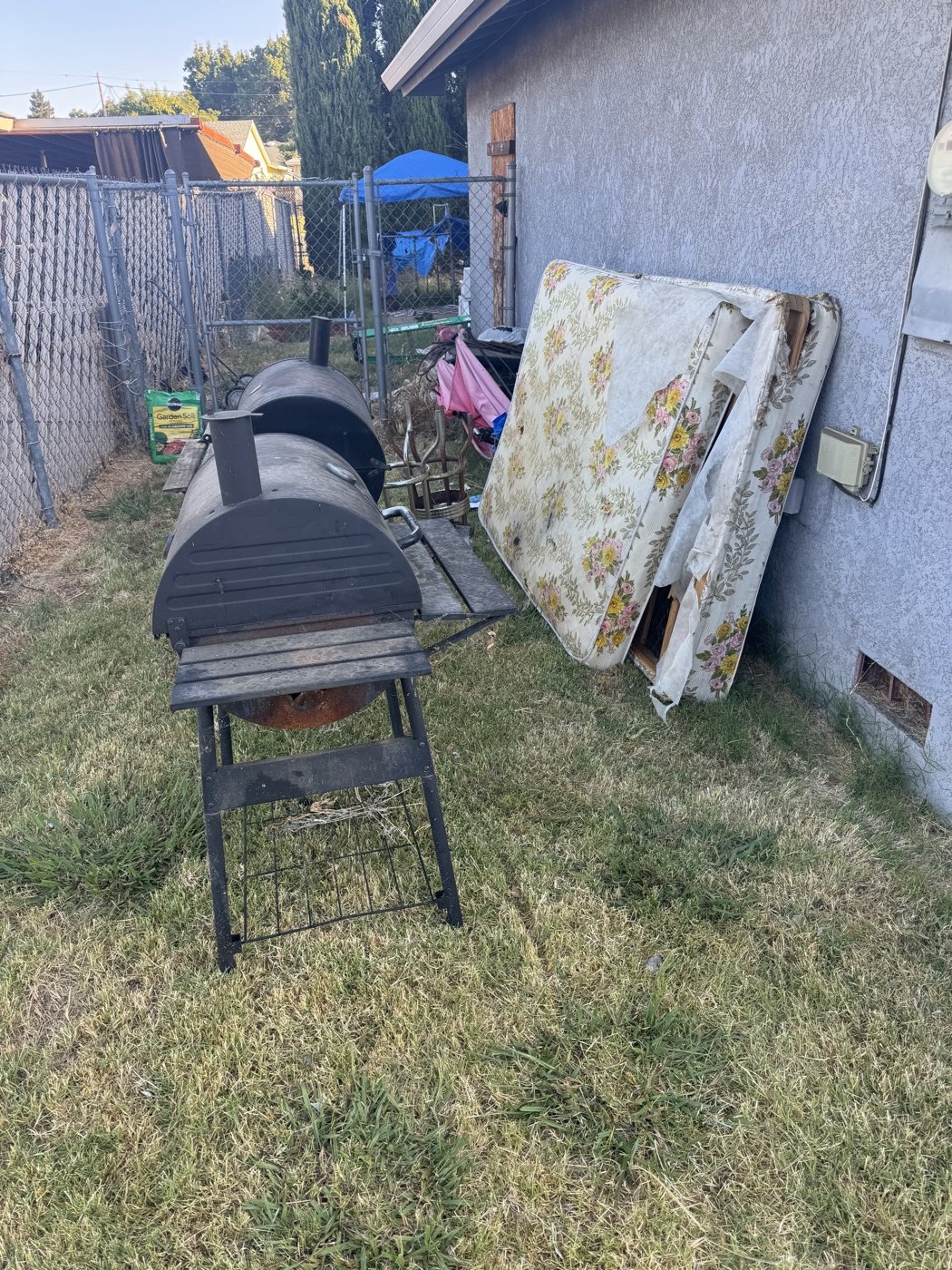 Before: driveway entry cluttered with bags and boxes